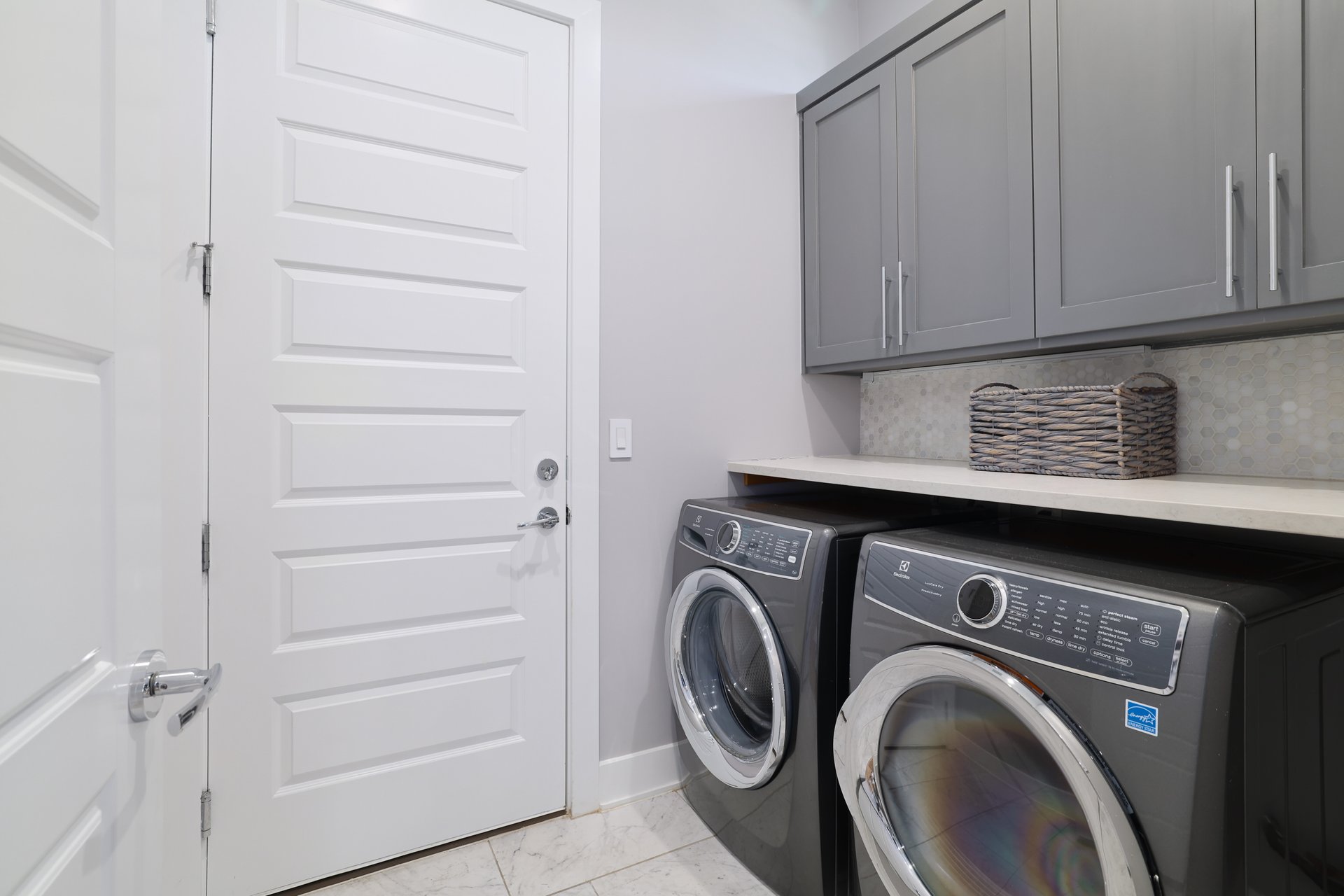1103 Saucedo Street, Unit 2 Austin, TX 78721 - Photo 21 of 26 The dedicated laundry room offers extra storage space and a convenient transition point from the attached garage