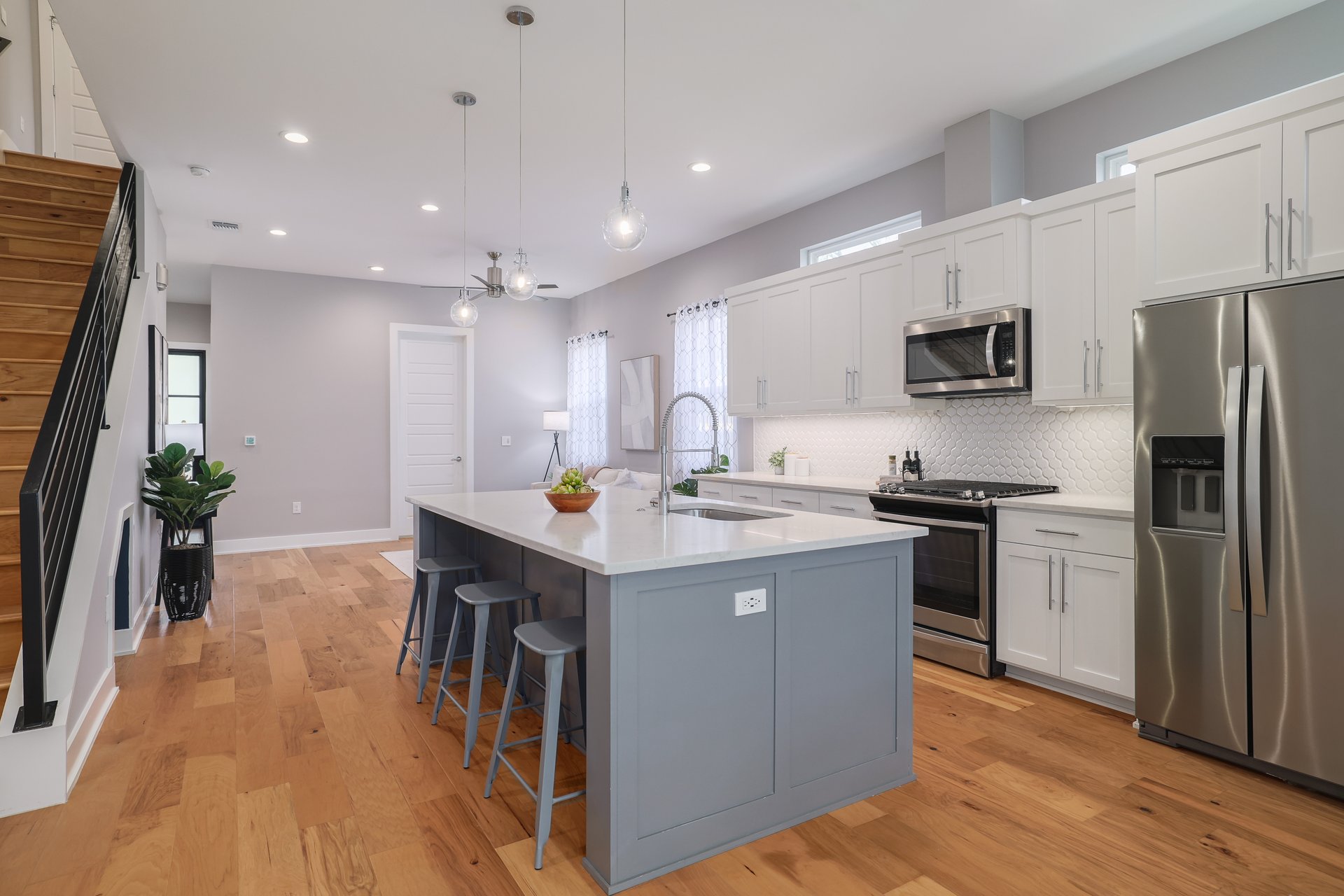 1103 Saucedo Street, Unit 2 Austin, TX 78721 - Photo 8 of 26 The extended quartz countertop creates a convenient breakfast bar, perfect for quick morning coffee or casual meals