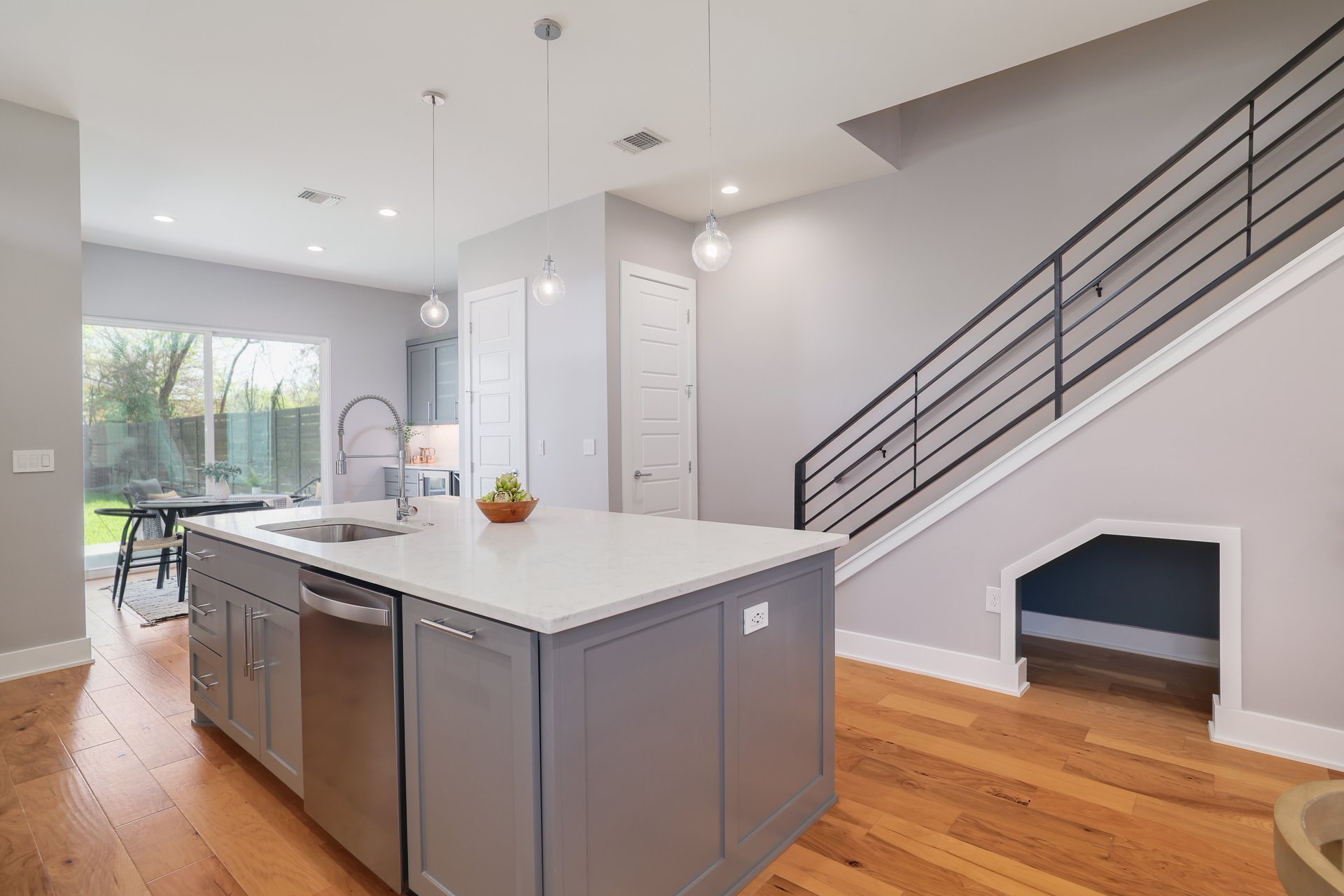 1103 Saucedo Street, Unit 2 Austin, TX 78721 - Photo 10 of 26 A thoughtful built-in dog nook is tucked away under the stairs, giving your four-legged roommate a dedicated, cozy spot of their own