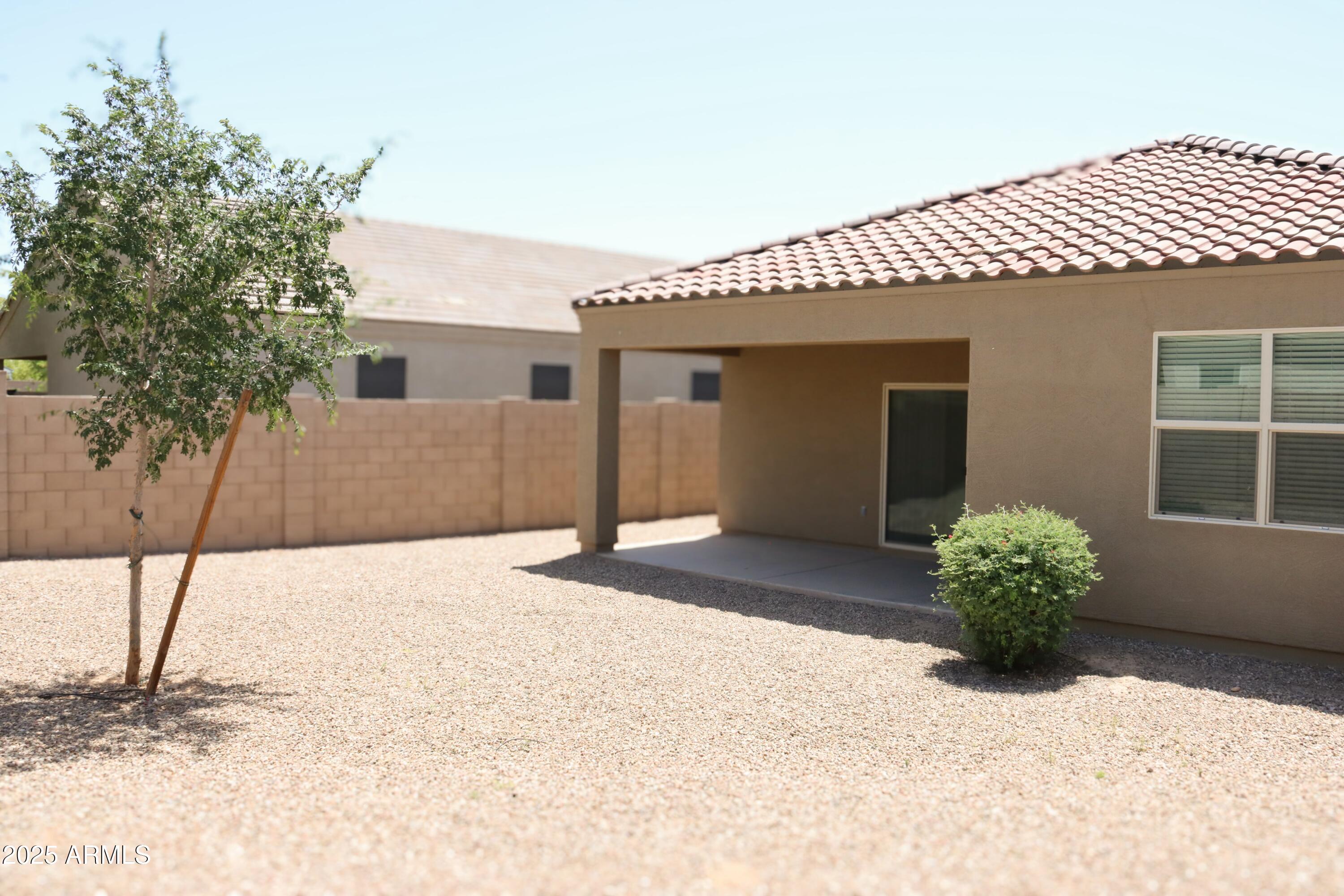 4734 East Pearl Road San Tan Valley, AZ 85143 - Photo 24 of 27 a white house with a yard and a garage