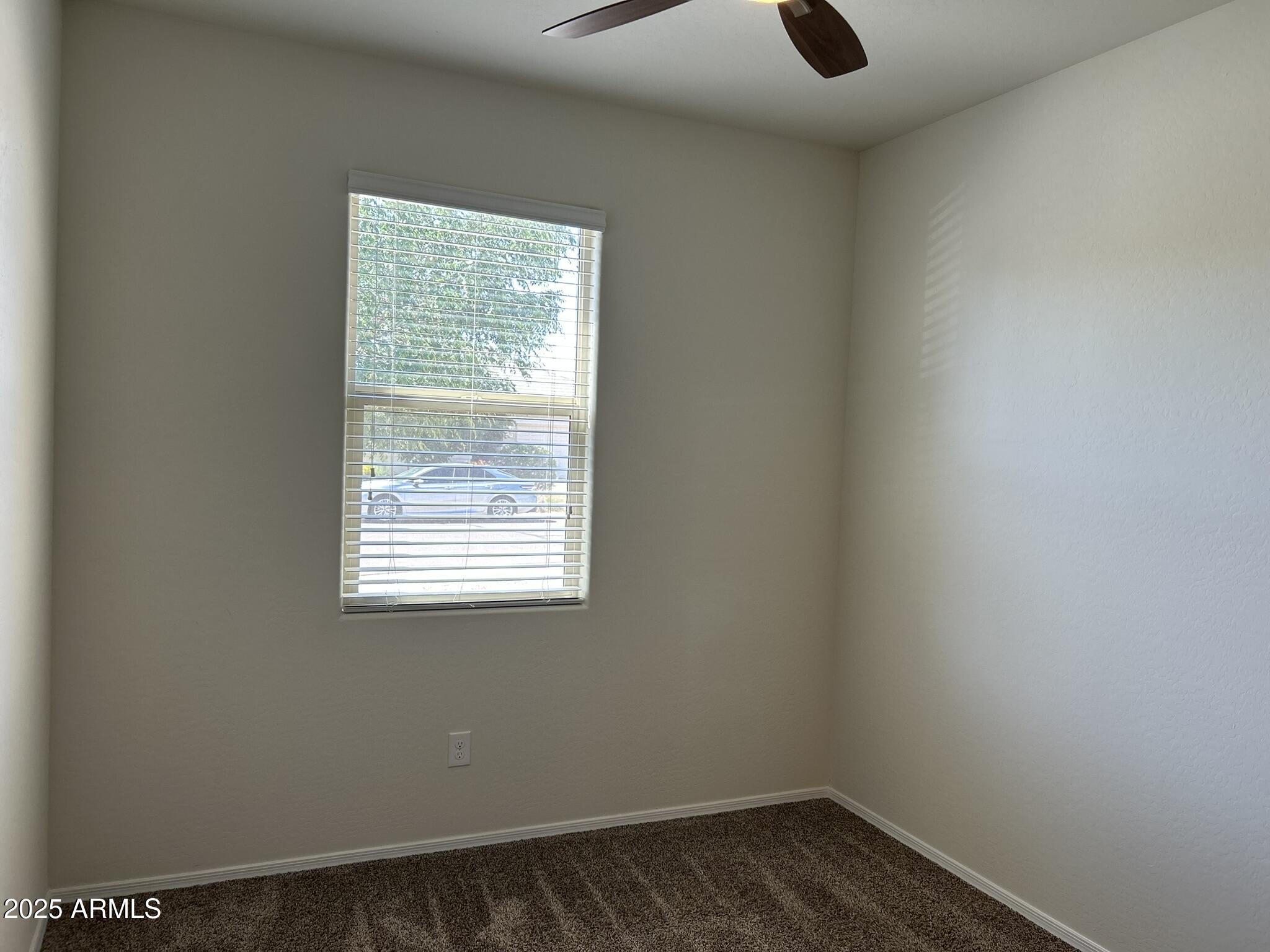 4734 East Pearl Road San Tan Valley, AZ 85143 - Photo 4 of 27 a view of an empty room with wooden floor and a window
