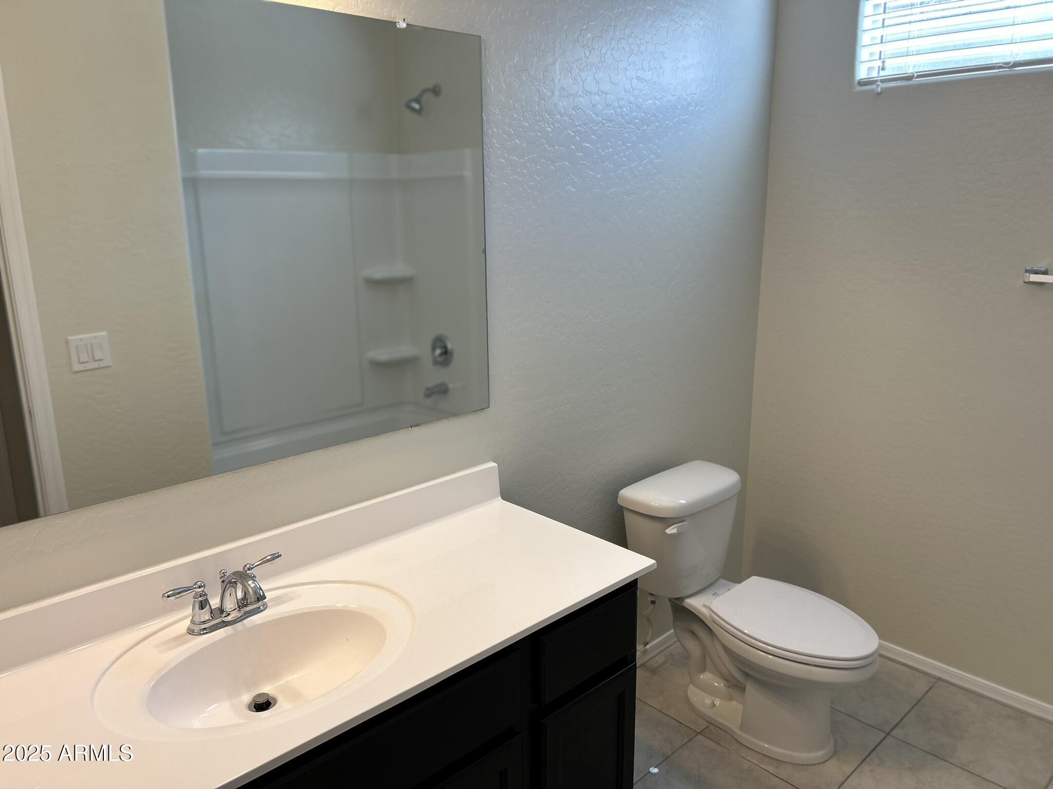 4734 East Pearl Road San Tan Valley, AZ 85143 - Photo 5 of 27 a bathroom with a sink a toilet and a mirror