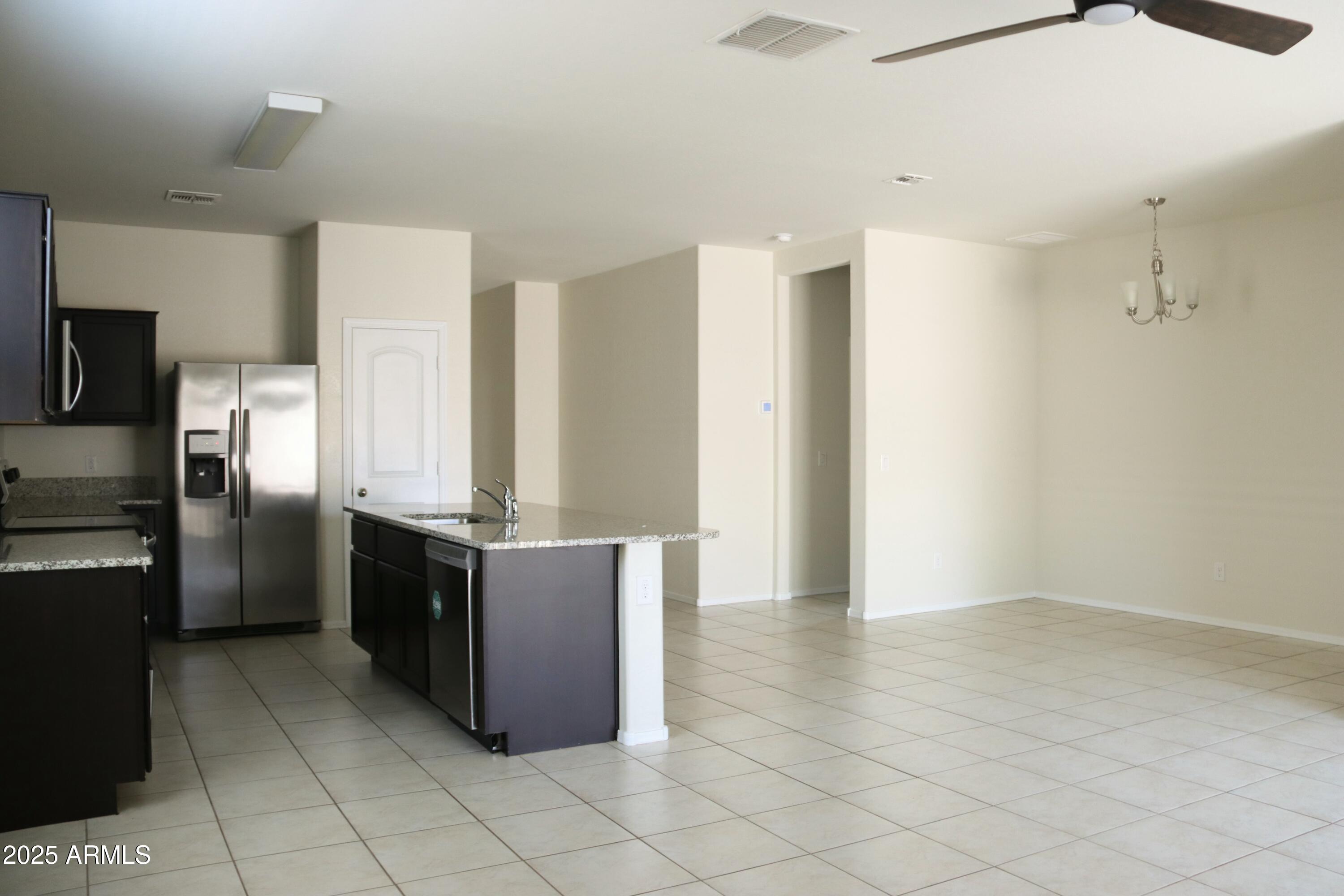4734 East Pearl Road San Tan Valley, AZ 85143 - Photo 8 of 27 a kitchen with stainless steel appliances granite countertop a refrigerator and a stove