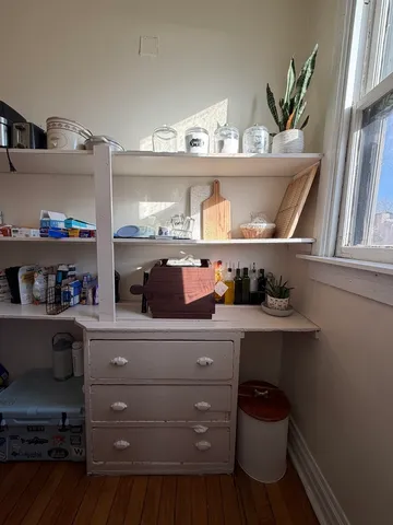 a kitchen with a cabinets and wooden floor