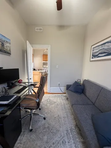 a living room with furniture and a computer