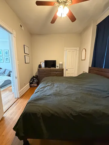 a bedroom with a bed and a chandelier