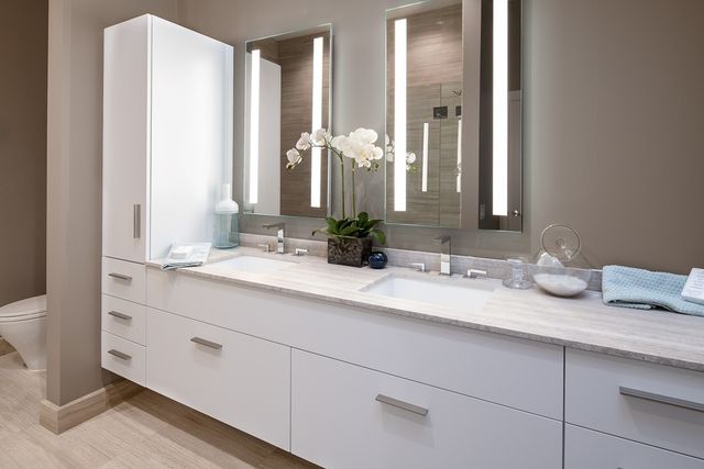 a bathroom with double vanity sinks and a mirror
