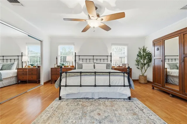a bedroom with a large bed and a chandelier