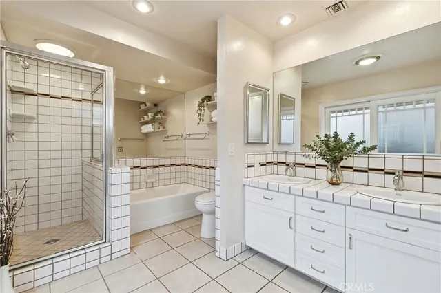 a bathroom with a shower sink and mirror