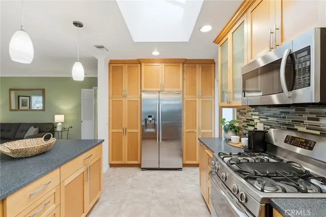 a kitchen with stainless steel appliances granite countertop a stove and a refrigerator