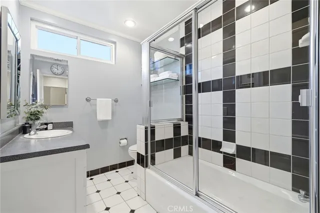 a bathroom with a bathtub sink mirror and shower