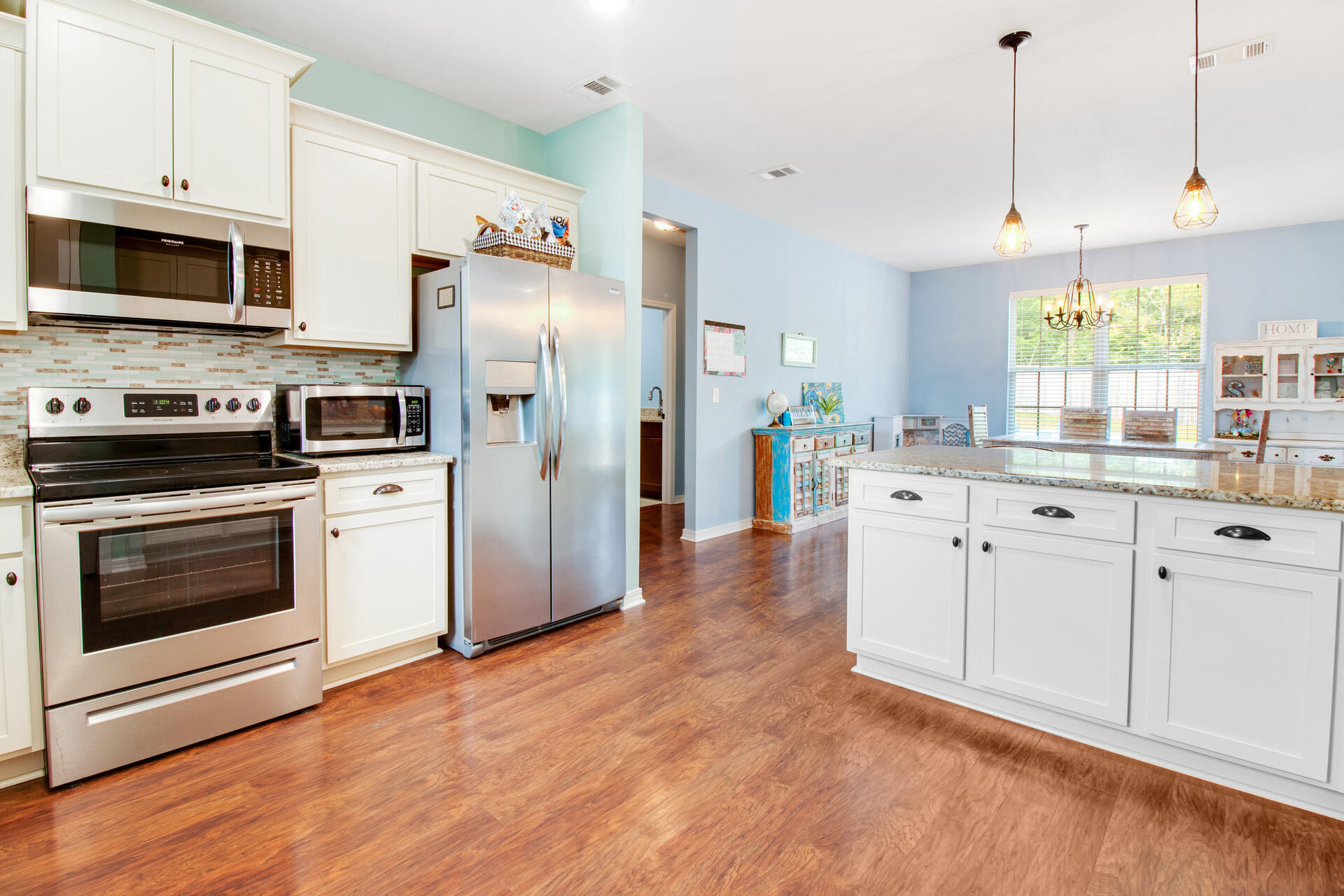 6212 Timberland Ridge Drive Crestview, FL 32539 - Photo 12 of 34 a kitchen with white cabinets and stainless steel appliances
