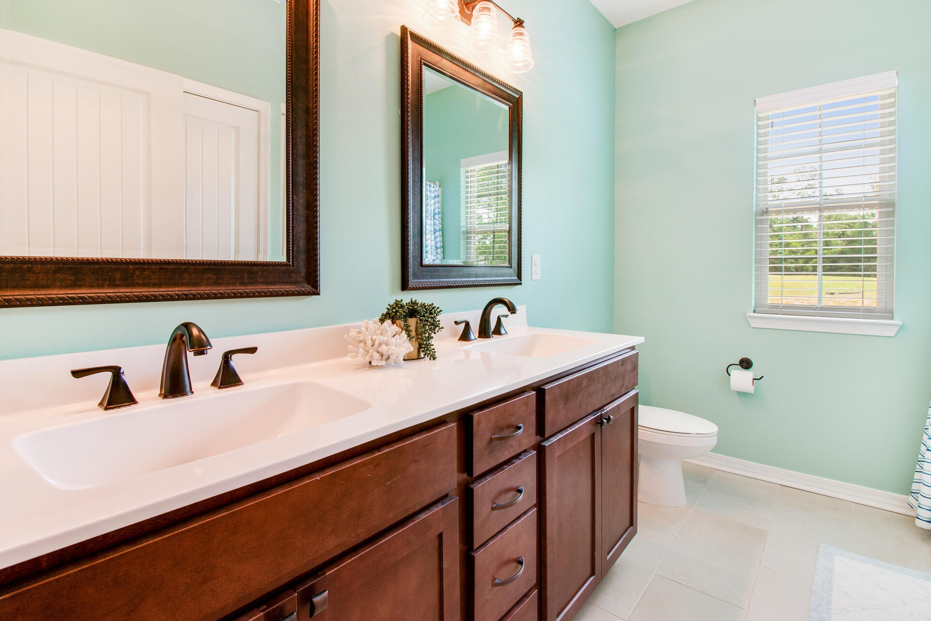 6212 Timberland Ridge Drive Crestview, FL 32539 - Photo 23 of 34 a bathroom with a double vanity sink and a mirror