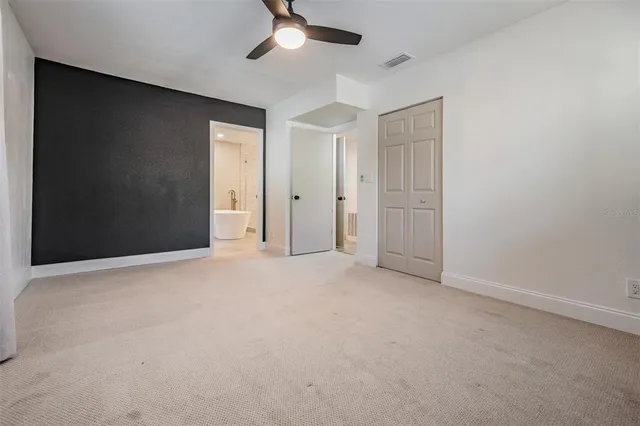 an empty room with a empty space and a ceiling fan