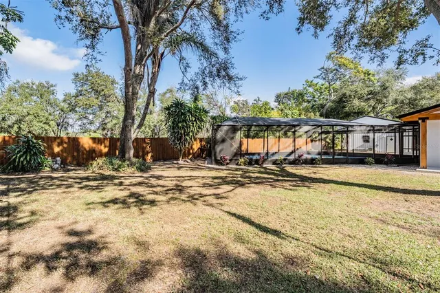 a view of a house with pool and sitting area