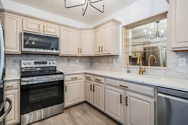 a kitchen with stainless steel appliances granite countertop a stove and a microwave