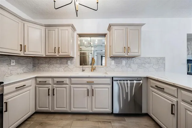 a kitchen with stainless steel appliances granite countertop a sink and cabinets with wooden floor