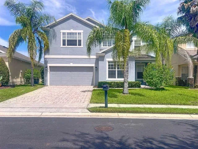 a front view of house with yard and green space