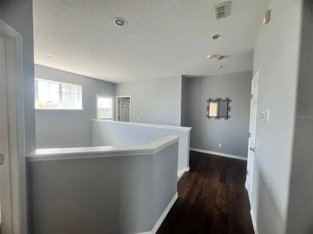 a view of wooden floor and windows in a room