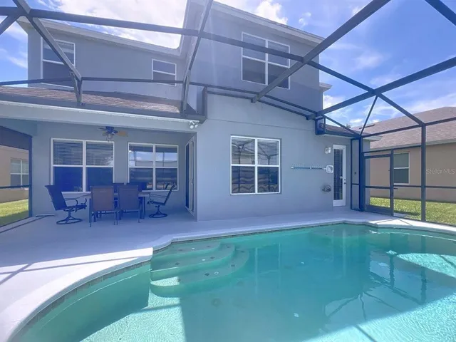 a view of a backyard with table and chairs