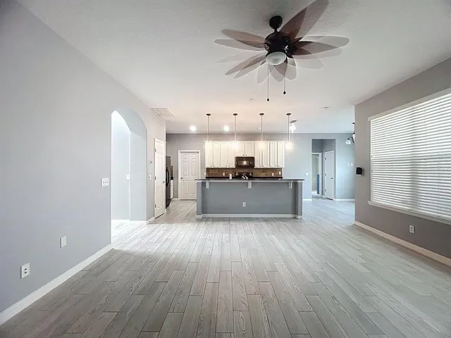 a view of a kitchen with a sink and a refrigerator