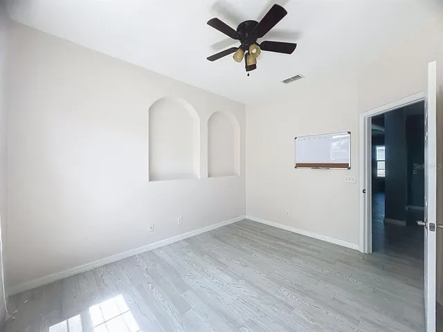 wooden floor in an empty room with a window