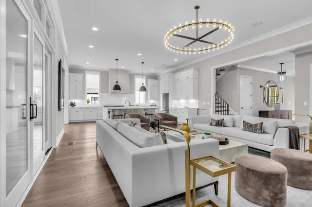 a kitchen with stainless steel appliances granite countertop a sink a stove and a wooden floors