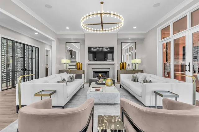 a kitchen with stainless steel appliances granite countertop a sink a stove a chimney a potted plant and a window