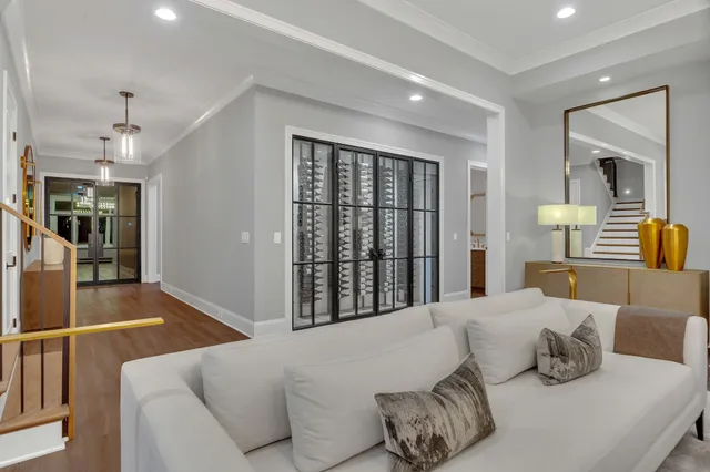 a kitchen with stainless steel appliances granite countertop a sink a counter space and a living room view