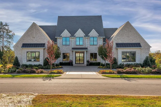 a front view of a house with swimming pool and yard