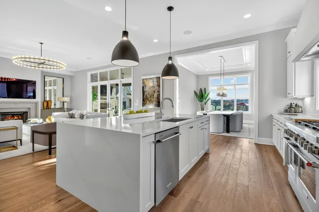 a spacious bathroom with a double vanity sink mirror and bathtub