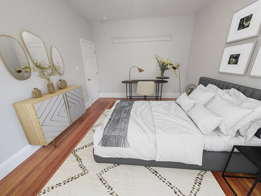 108 Callender Street, Unit 1 Boston, MA 02124 - Photo 1 of 9 a bedroom with a bed and a chair