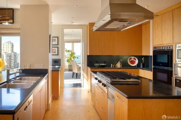 a kitchen with stainless steel appliances granite countertop a stove and a sink