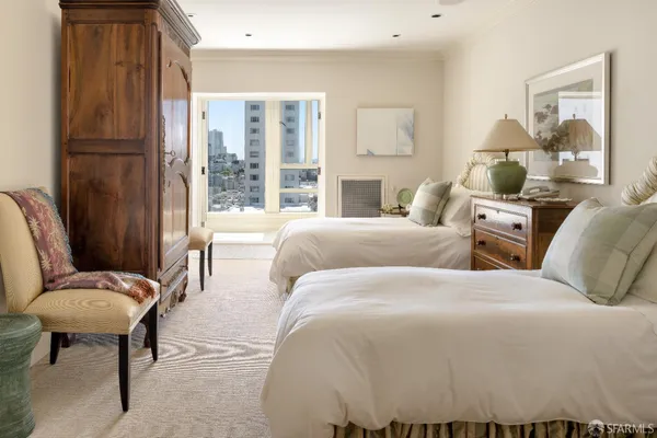 a bedroom with a bed and a large window