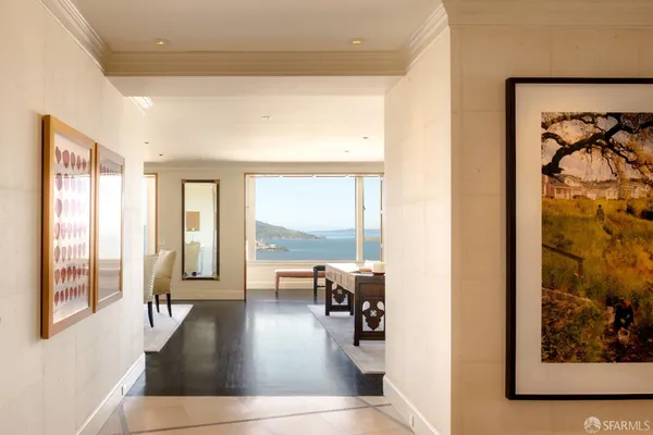 a living room with furniture and floor to ceiling windows