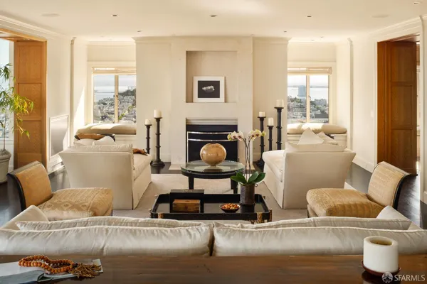 a living room with furniture and a fireplace