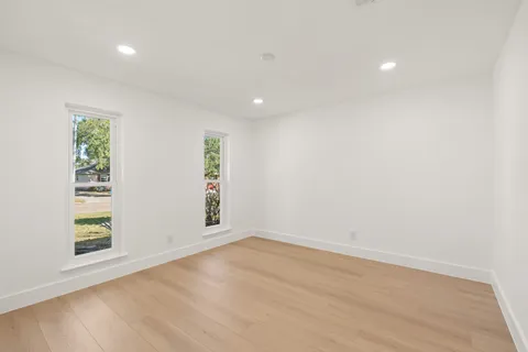 an empty room with windows and entrance