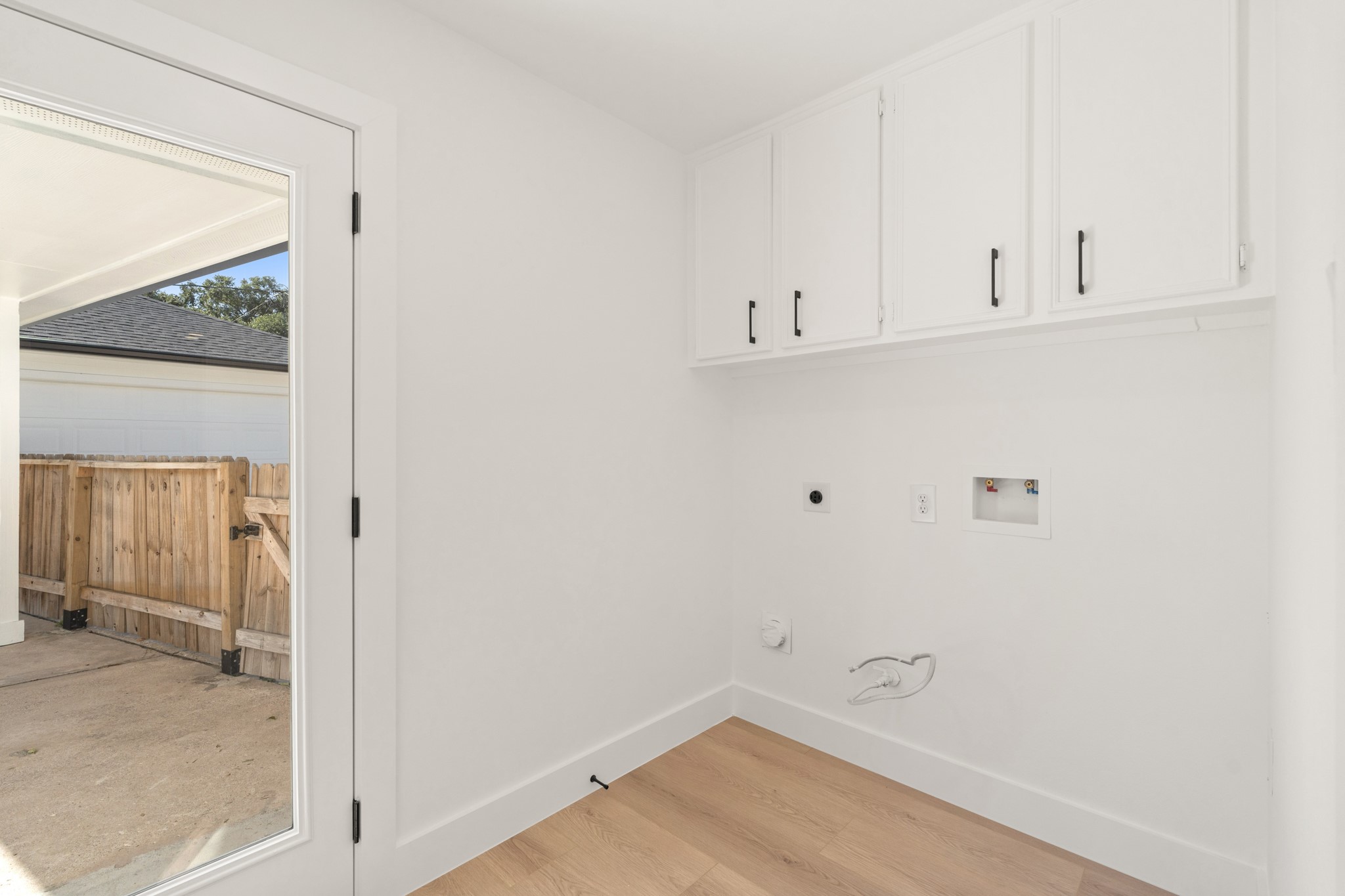 7631 Westwind Lane Houston, TX 77071 - Photo 18 of 21 a view of a kitchen with white cabinets and wooden floor