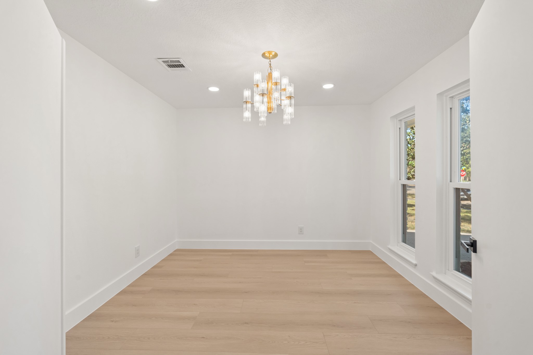7631 Westwind Lane Houston, TX 77071 - Photo 7 of 21 wooden floor in an empty room with a window