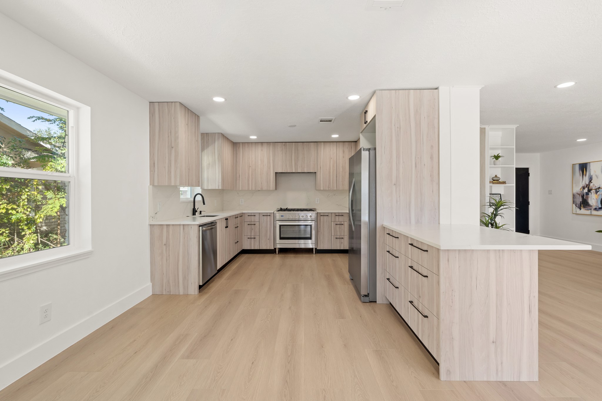 7631 Westwind Lane Houston, TX 77071 - Photo 8 of 21 a kitchen with stainless steel appliances a sink and a refrigerator