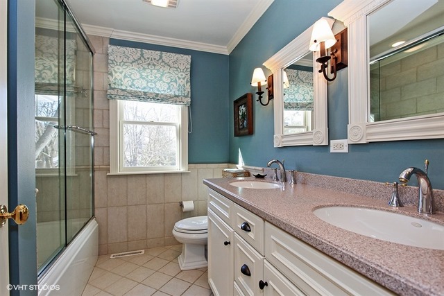 804 Valley Road Lake Forest, IL 60045 - Photo 22 of 25 a bathroom with a granite countertop sink a toilet a mirror and window