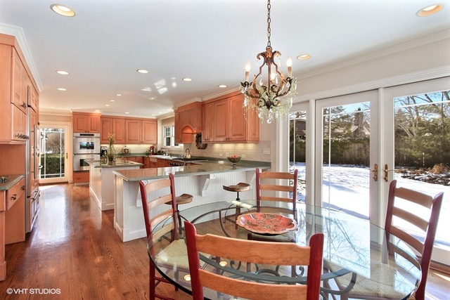 804 Valley Road Lake Forest, IL 60045 - Photo 8 of 25 a dining room with furniture a chandelier and wooden floor