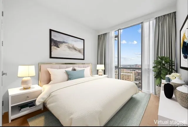 a bedroom with a large bed and a potted plant