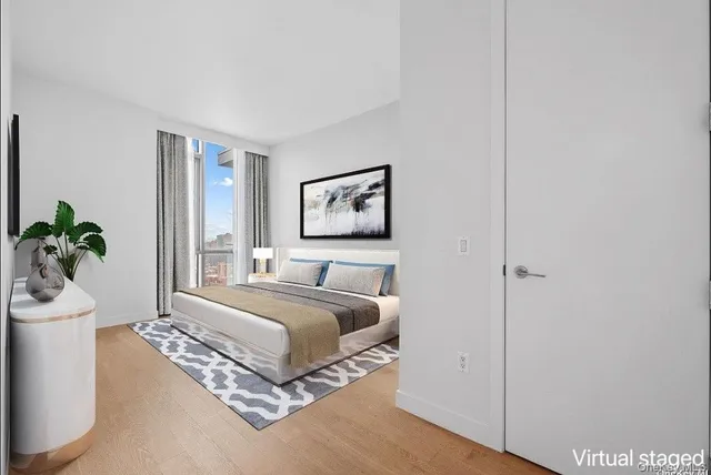 a spacious bedroom with a bed and a potted plant