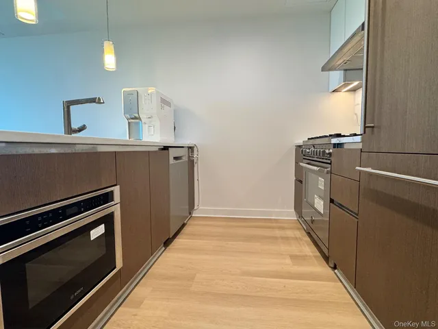 a kitchen with stove and cabinets