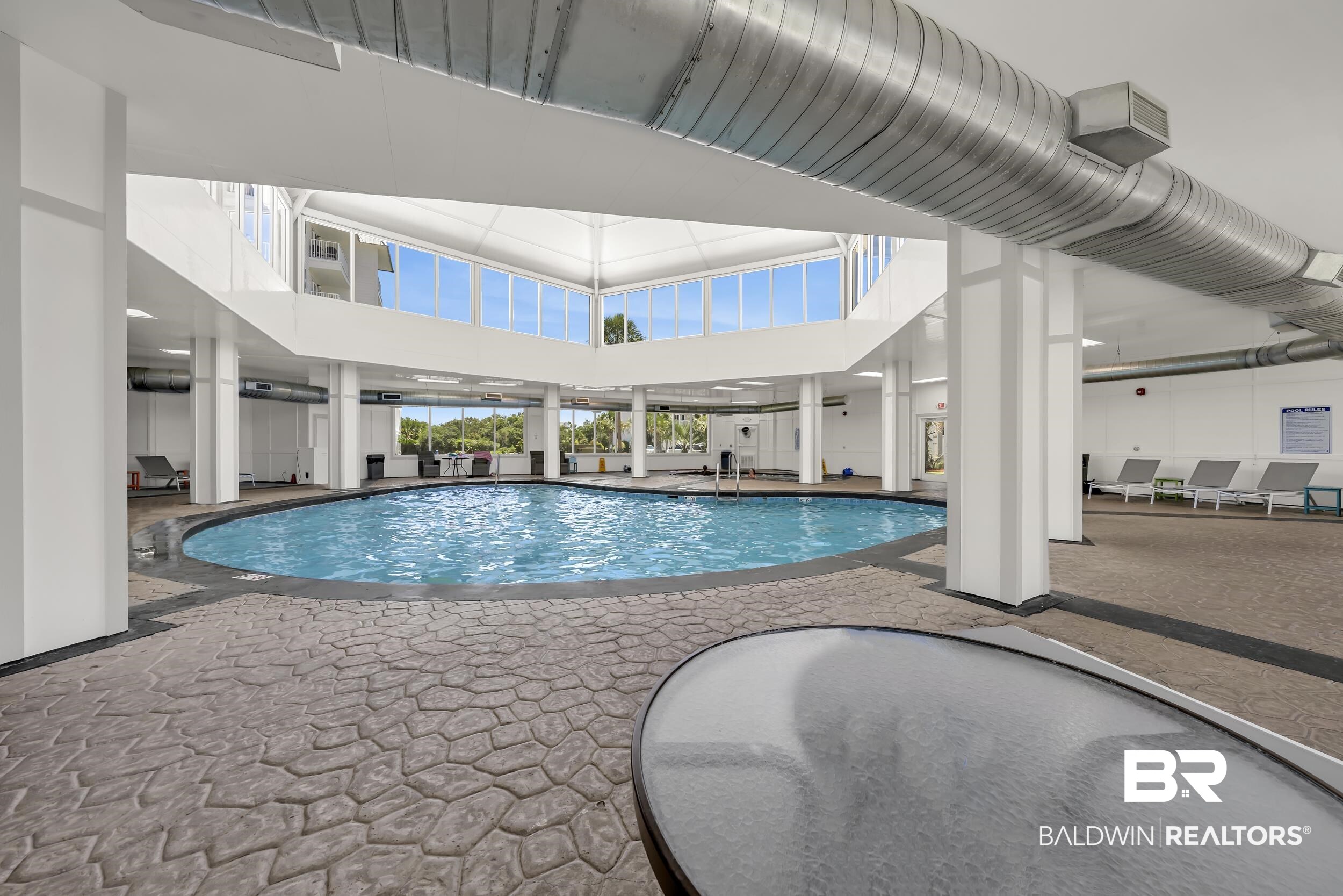 400 Plantation Road, Unit 2118 Gulf Shores, AL 36542 - Photo 33 of 59 Indoor swimming pool featuring a curved design and a surrounding stamped concrete deck
