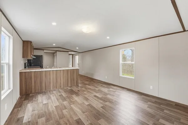 an empty room with wooden floor and a window