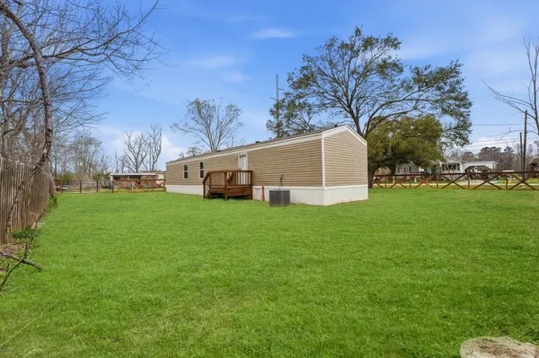 a view of a backyard with large trees
