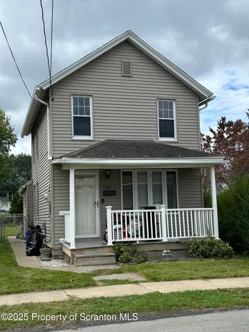 a view of a house with a yard and plants