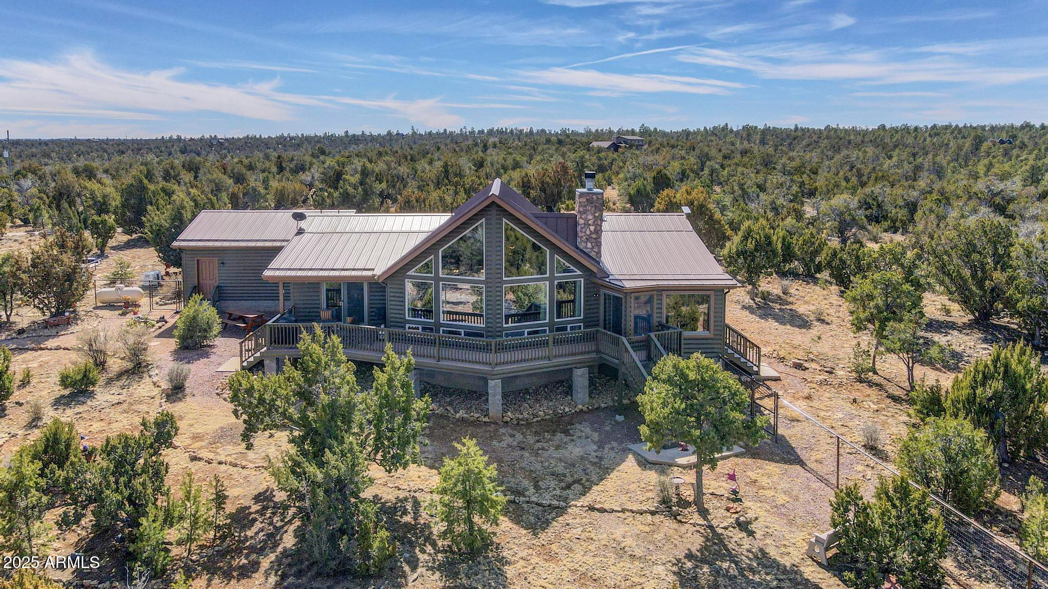 4018 Sunset Rdg Loop Happy Jack, AZ 86024 - Photo 1 of 46 a view of a big house with a big yard and large tree